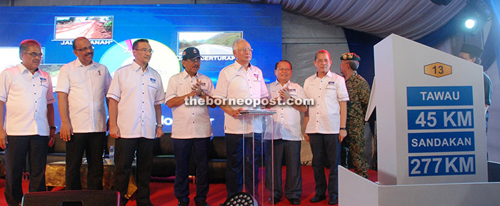 Najib  launches the Pan Borneo project at SMK Balung here while others look on.  