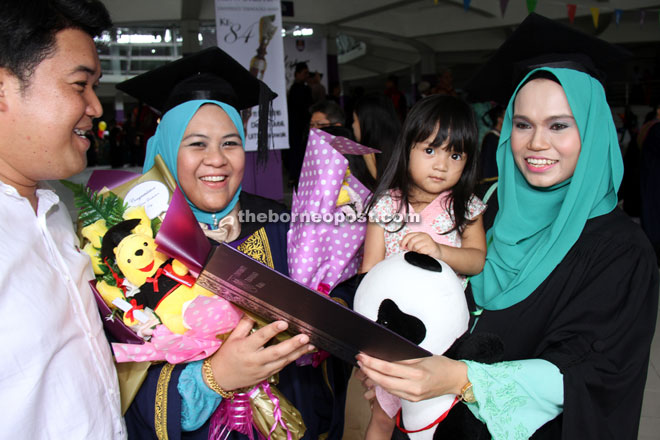 A graduate (second left) shares her joy with her lecturer and Public and International Relations coordinator Ardiana Mazwa Raudah Amir Abdullah (right). 