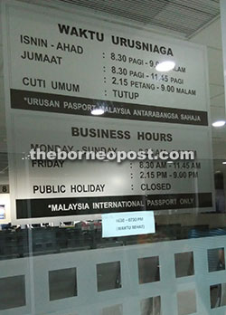 A sign showing the opening hours at the Immigration Department counter.