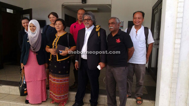 Jannie (front row, second left) outside the court with Ram (second right) after the court proceedings yesterday.