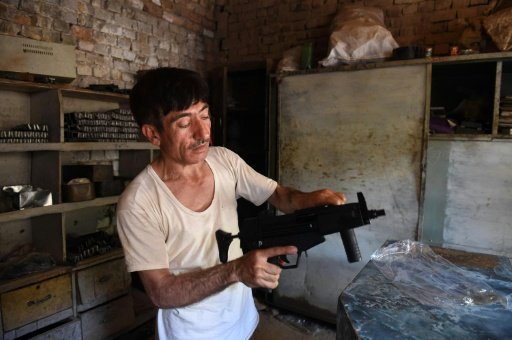 Pakistani gunsmith Khitab Gul tests a gun near a workshop in the tribal area of Darra Adamkhel, some 35 kilometres south of Peshawarby Sajjad Tarakzai | AFP photo