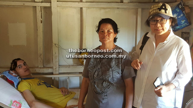 Liew (right) with the mother and son at their home.