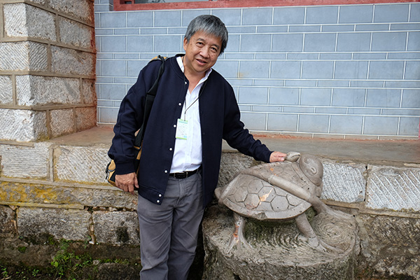 The Borneo Post editor Francis Chan touching the turtle and wishing for good luck.