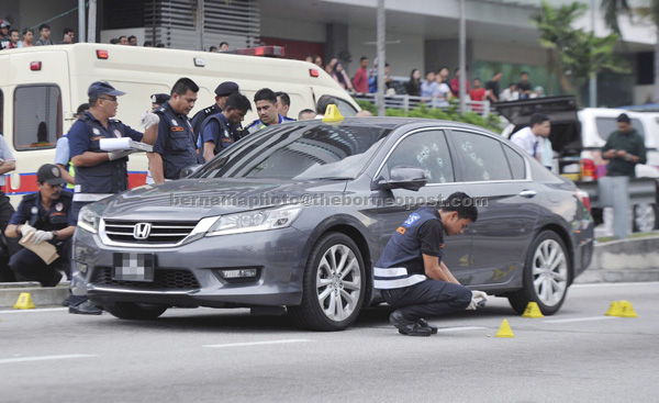 Police forensic personnel conducting investigation at the shooting scene in Danau Kota, Kuala Lumpur yesterday. — Bernama photo   