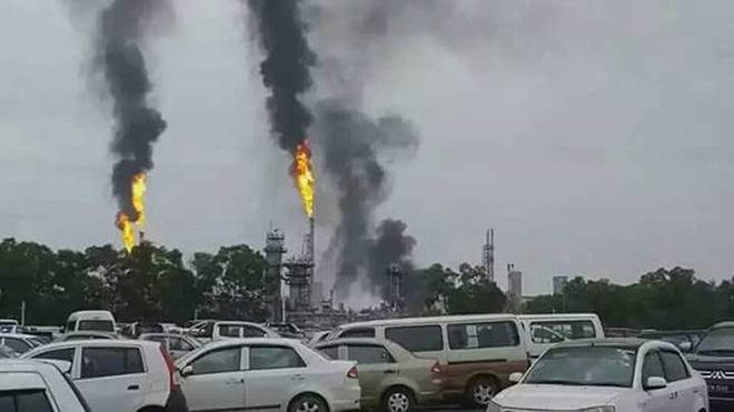 Black and white smoke billowing from one of the facilities at Petronas LNG Complex.