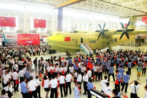 A crowd gathers at a ceremony to unveil the AG600 amphibious plane, in Zhuhai, southern China's Guangdong Province, on July 23, 2016. Photo by AFP
