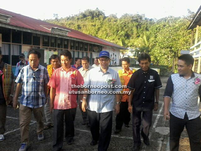 Jamit (front, centre), accompanied by Jimmy on his left and others, on a tour of SK Trusa.