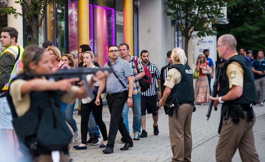 Shoppers rushed away from the Olympia Einkaufzentrum (OEZ) shopping mall in Munich as the building was surrounded by armed police and emergency vehicles. Photo by AFP