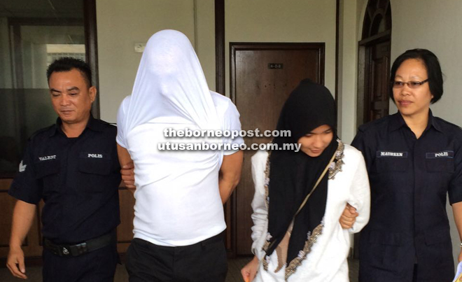 Eshyam and Siti (centre) being led away after they were sentenced by the Sessions Court yesterday. 