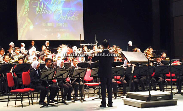 The SainsKu Winds Orchestra performs at an event.