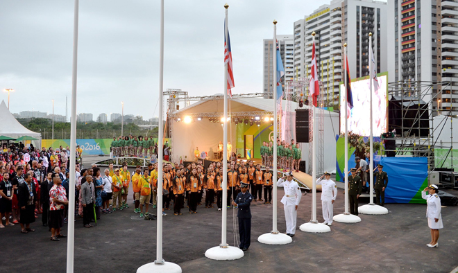 The Malaysian contingent sings the national anthem NegaraKu, as the Jalur Gemilang is unfurled at the Games’ Village in the presence of about 30 Malaysian athletes, coaches and officials, joined by athletes from Angola, Canada and Fiji who shared the stage for the flag raising ceremony. — Bernama photo