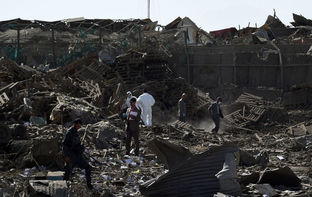 Security personnel investigate the site of a powerful truck bomb attack at a hotel for foreigners in Kabul. Photo by AFP