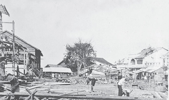The captured scene shows the aft ermath of the â€˜Great Fire of Sibuâ€™ in 1928. All features as seen on this photo are gone, except for the tree at the centre and the concrete block on the right. The raintree in front of Tua Pek Kong Temple is now the oldest tree in Sibu Central Business District. Tua Pek Kong Temple was also rebuilt.