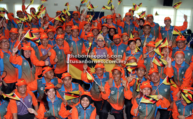 Fatimah (in the middle) with the deaf athletes representing Sarawak at the upcoming Sopma 2016. — Photos by Chimon Upon 