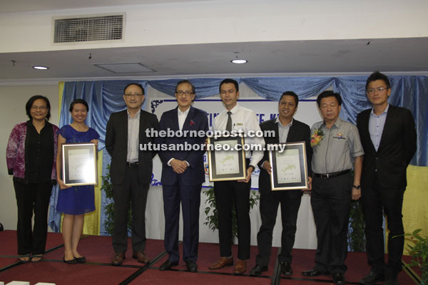 Masidi (fourth left) and Yeo (second right) in a photo opportunity with restaurateurs who received  certificates of acknowledgement for pledging to stop serving shark fins to patrons. 