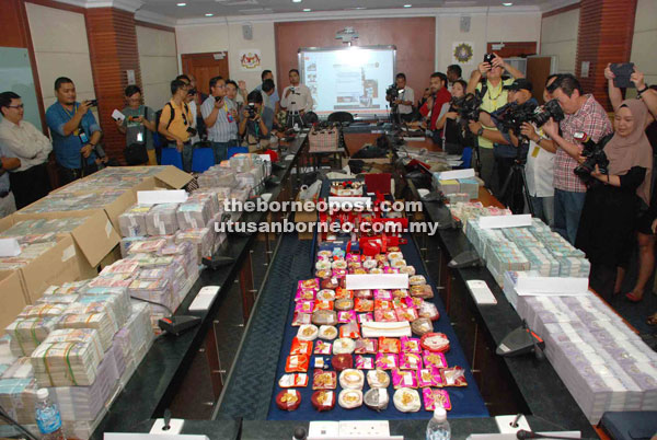 Cash amounting to RM52 million, jewellery, luxury watches and foreign currencies that were seized by MACC. (File photo)