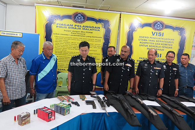 Dev Kumar (fourth right), Stanley (third right) and others looking at the seized weapons during the press conference held at Miri police headquarters yesterday.