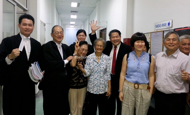 Dr Ting (fourth right) with his lawyers and family members after the court proceedings.