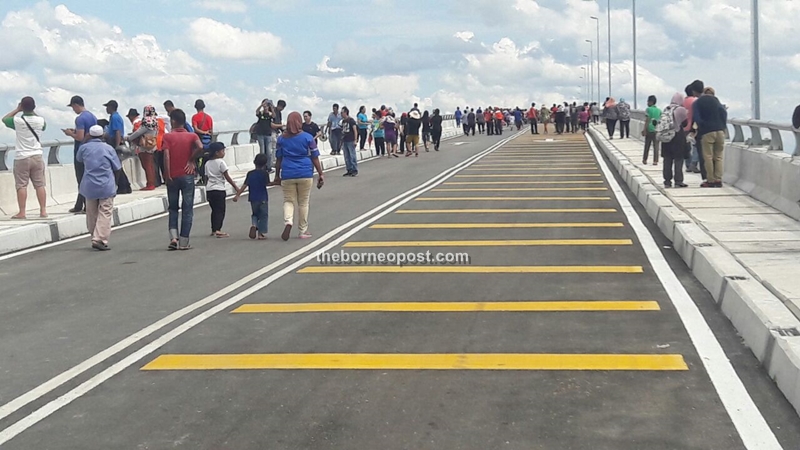 Members of the public throng the bridge moments after its opening.