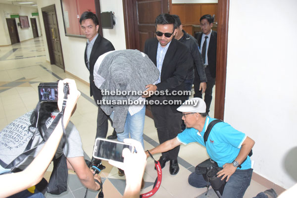 The accused being escorted out of the courtroom.