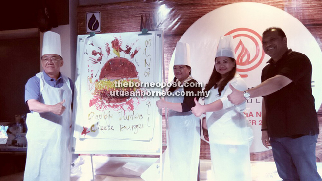 Pandai (right) gives his thumbs-up to the team that won the painting competition during the media gathering themed ‘Master Chef’. 