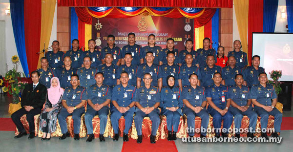 Wan Mohd Nor (seated centre) with Nordin (seated fifth left), Zuraidah (seated fifth right) officers and recipients yesterday.