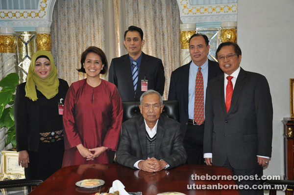 Adenan (seated) in a photo call with (from left) Aziza, Aireen, Muhammad Yusran, Zamani and Abang Johari.