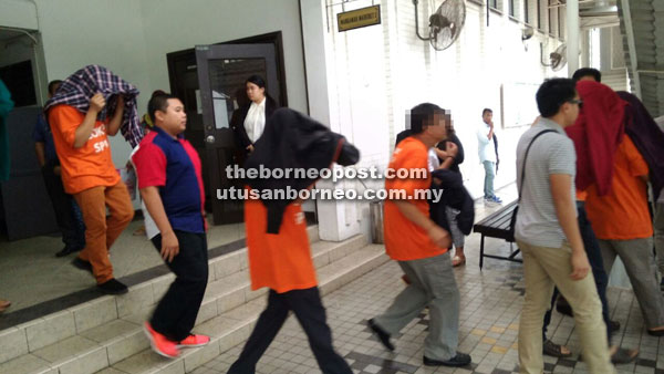 Some of the suspects leaving the courtroom at the Kota Kinabalu Courthouse after their release yesterday.