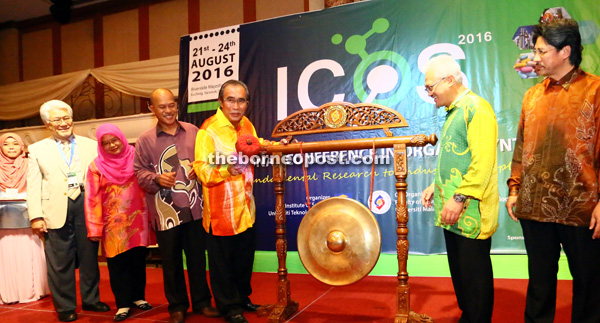 Len Talif (fifth left) striking the gong to officiate at ICOS while Jamil (second right) and others look on. - Photo by Muhammad Rais Sanusi 