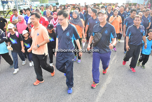 Hii (left) and others participate in ‘Walk A Mile’ programme at the SWB compound.