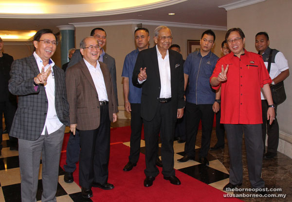 Adenan (second right) giving the peace sign with deputy chief ministers Datuk Amar Abang Johari Tun Openg (right), Datuk Amar Douglas Embas Uggah (second left) and PBB secretary-general Datuk Stephen Rundi Itom, before chairing a PBB meeting. — Photo by Chimon Upon