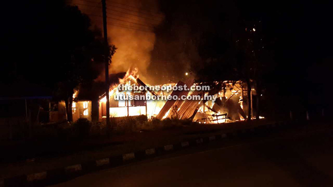 The raging blaze engulfing the vacant wooden house.