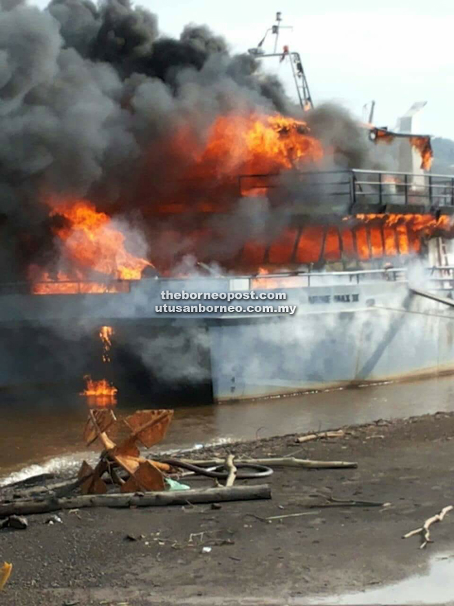Fire razing on the ship docked near the bank of Kemena River.