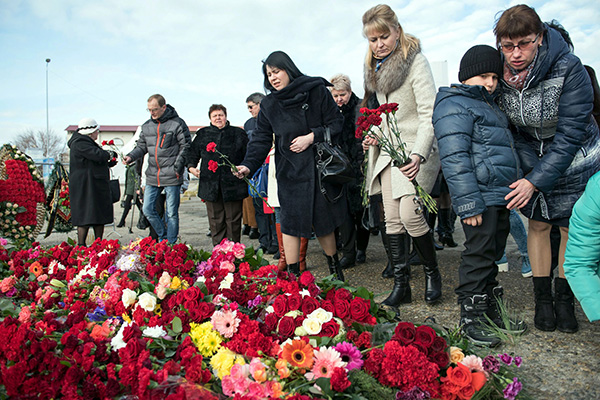 People lay flowers at the Sochi embankment the day after a Russian military plane crashed, the Russian military plane crashed on its way to Syria on Dec 25, with no sign of survivors among the 92 onboard, who included dozens of Red Army Choir members heading to celebrate the New Year with troops. — AFP photo