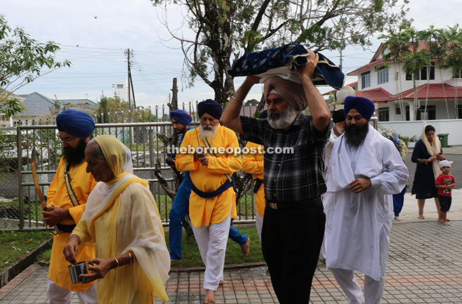 Karambir given the honour to carry the Sri Guru Granth Sahib on his head towards his home. 