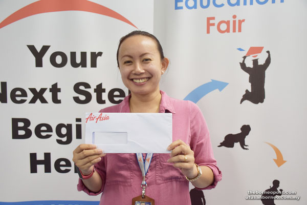 BPIEF secretariat Valerie Pawa Lang holds an AirAsia ticket.