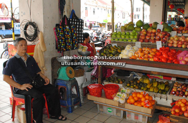 Teo looks after his fruit stall at the Central Market.