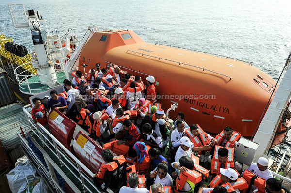 Volunteers taking part in a fire drill on the Nautical Aliya. — Bernama photo