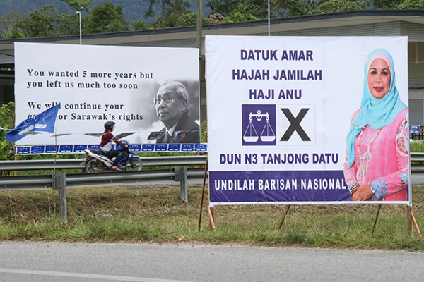 An election poster of Jamilah juxtaposed with that of her late husband and former Chief Minister Datuk Patinggi Tan Sri Tan Sri Adenan Satem. — Photo by Chimon Upon