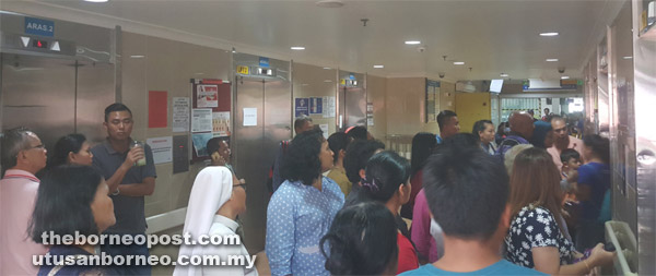 People wait for their turn to use the functioning elevators.