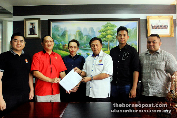 Mawan (third right) accepts the invitation letter to attend the welcome and prize-giving ceremonies of the futsal tournament from Churchill, as (from left) Surai, Abner, Andrew and Desmond look on. — Photo by Jeffery Mostapa