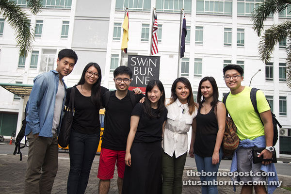 A file photo of students posing in front of the Swinburne University of Technology Sarawak Campus.  